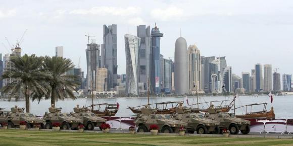 Members of the Qatari Armed Forces travel in armoured personnel carriers during National Day celebrations in Doha