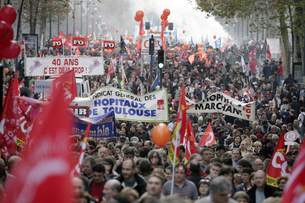 Private and public sector workers take part in a demonstration over pension reforms in Toulouse
